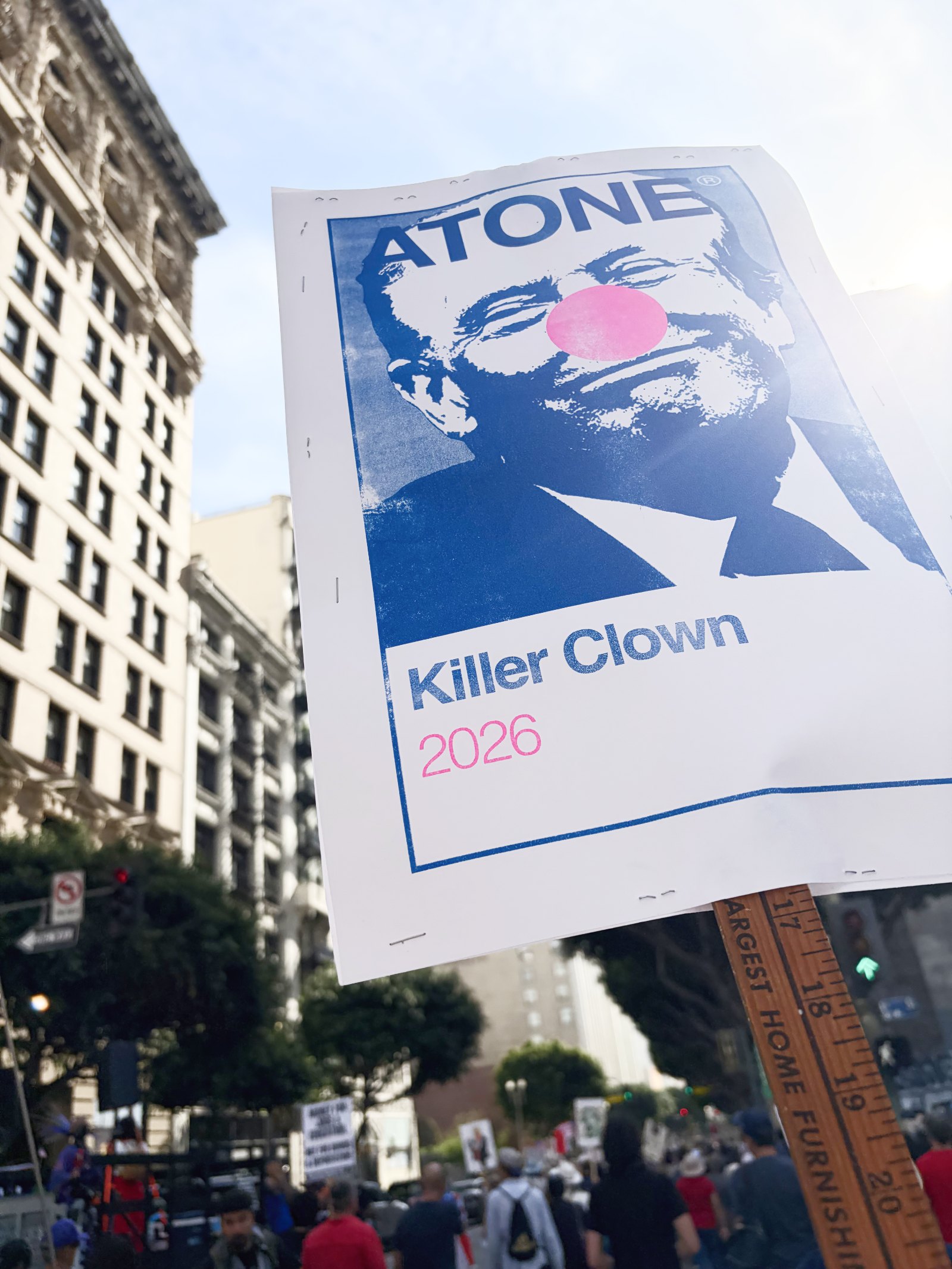 Atone poster held at a protest